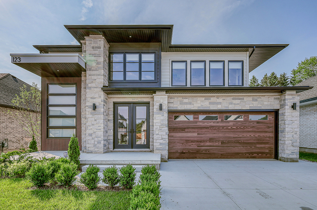 Exterior photo of front entry way with garage door and front porch.